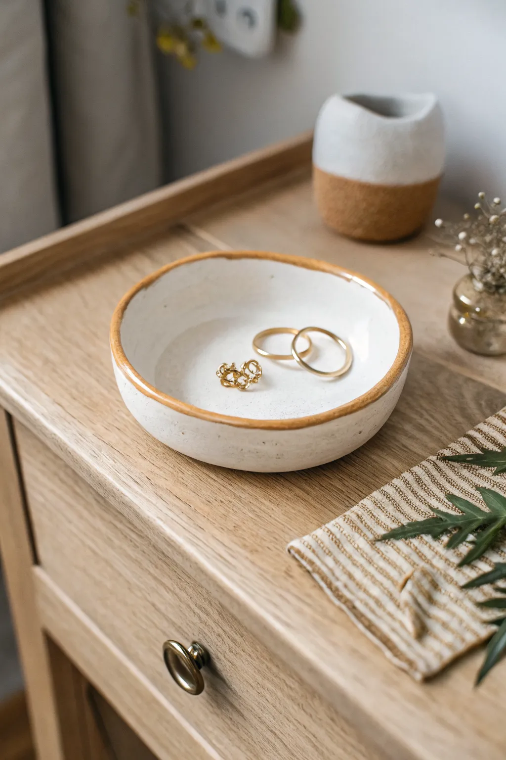 Minimal oval air clay trinket dish with a painted rim, made for rings and everyday earrings.