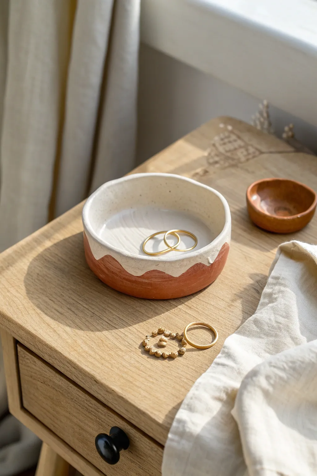 Simple air dry clay trinket dish with wavy edge, two-tone paint, perfect for jewelry.