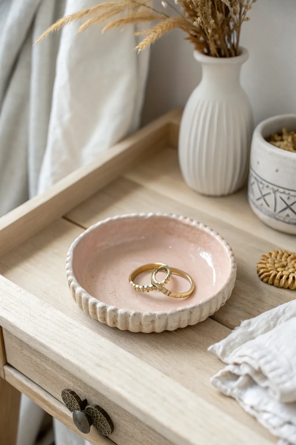Classic air dry clay ring dish in soft blush, styled minimal and boho on a light wood nightstand