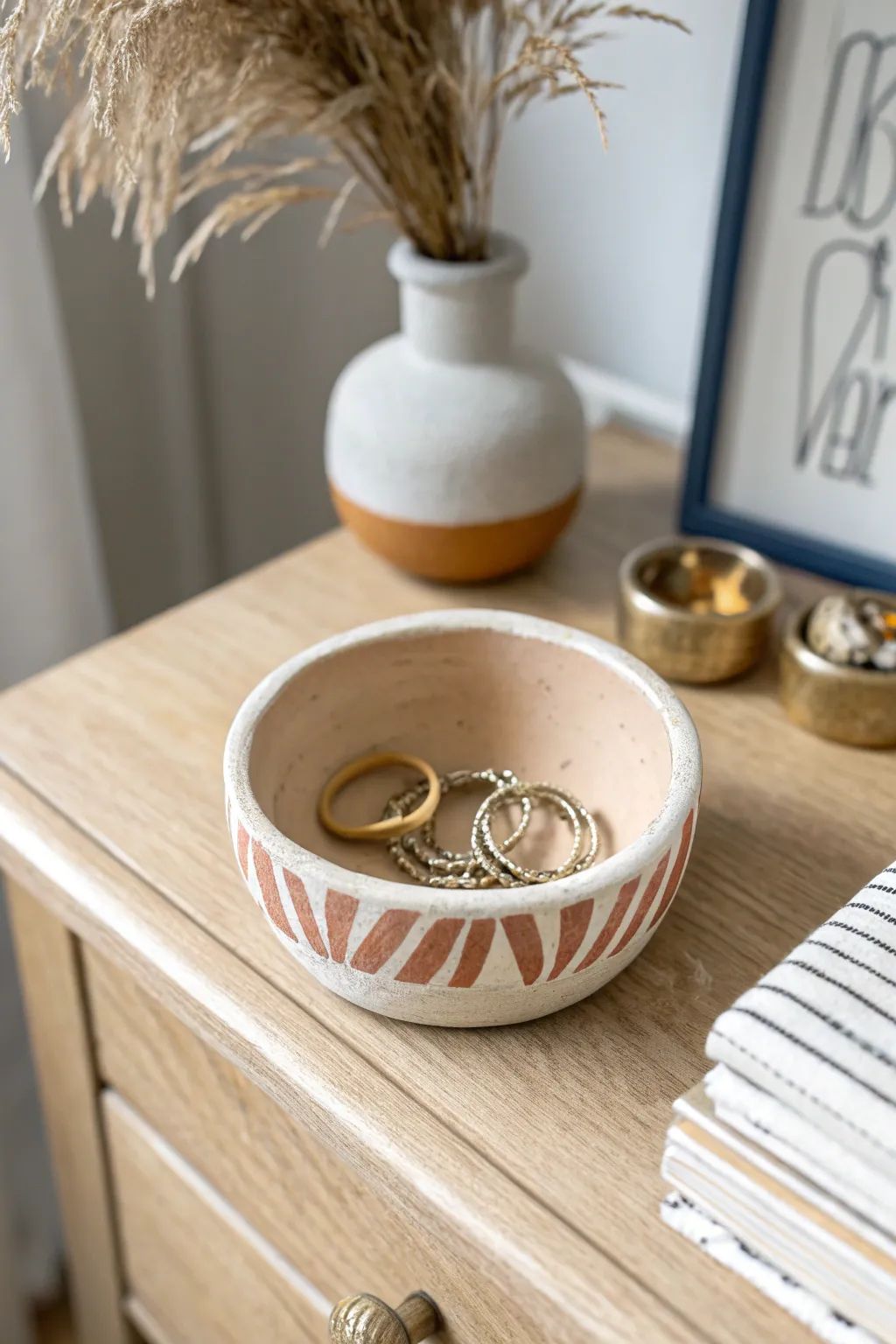 Minimal air dry clay pinch pot dish with soft stripes, perfect for rings and pins.