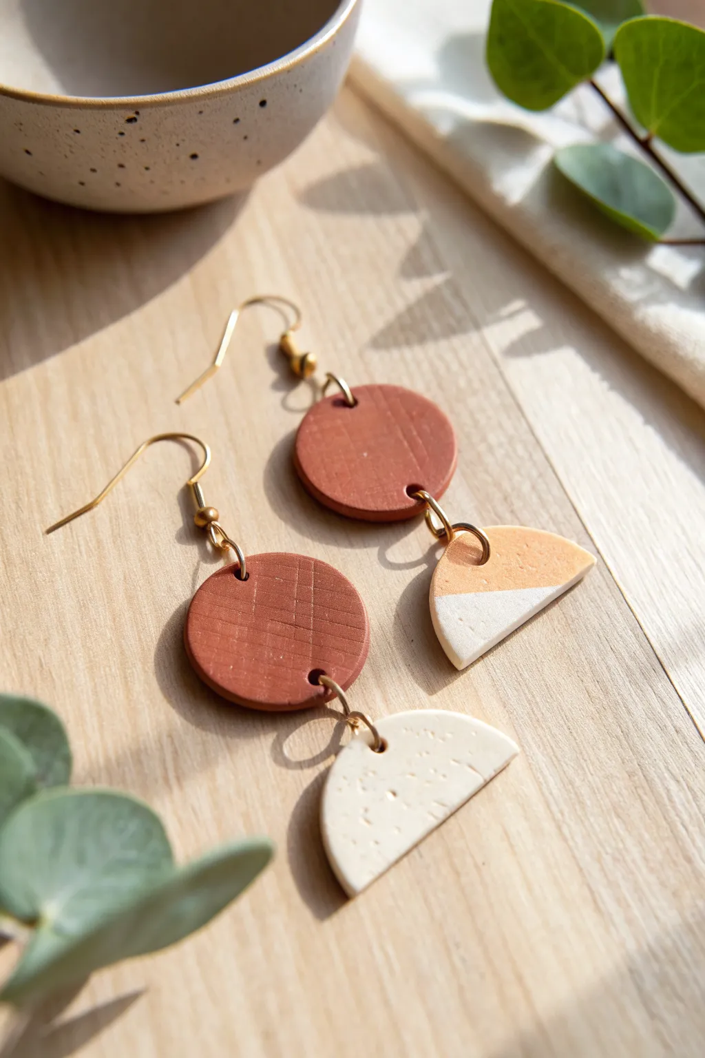Terracotta and cream geometric dangle earrings in matte air-dry clay, minimalist and boho.