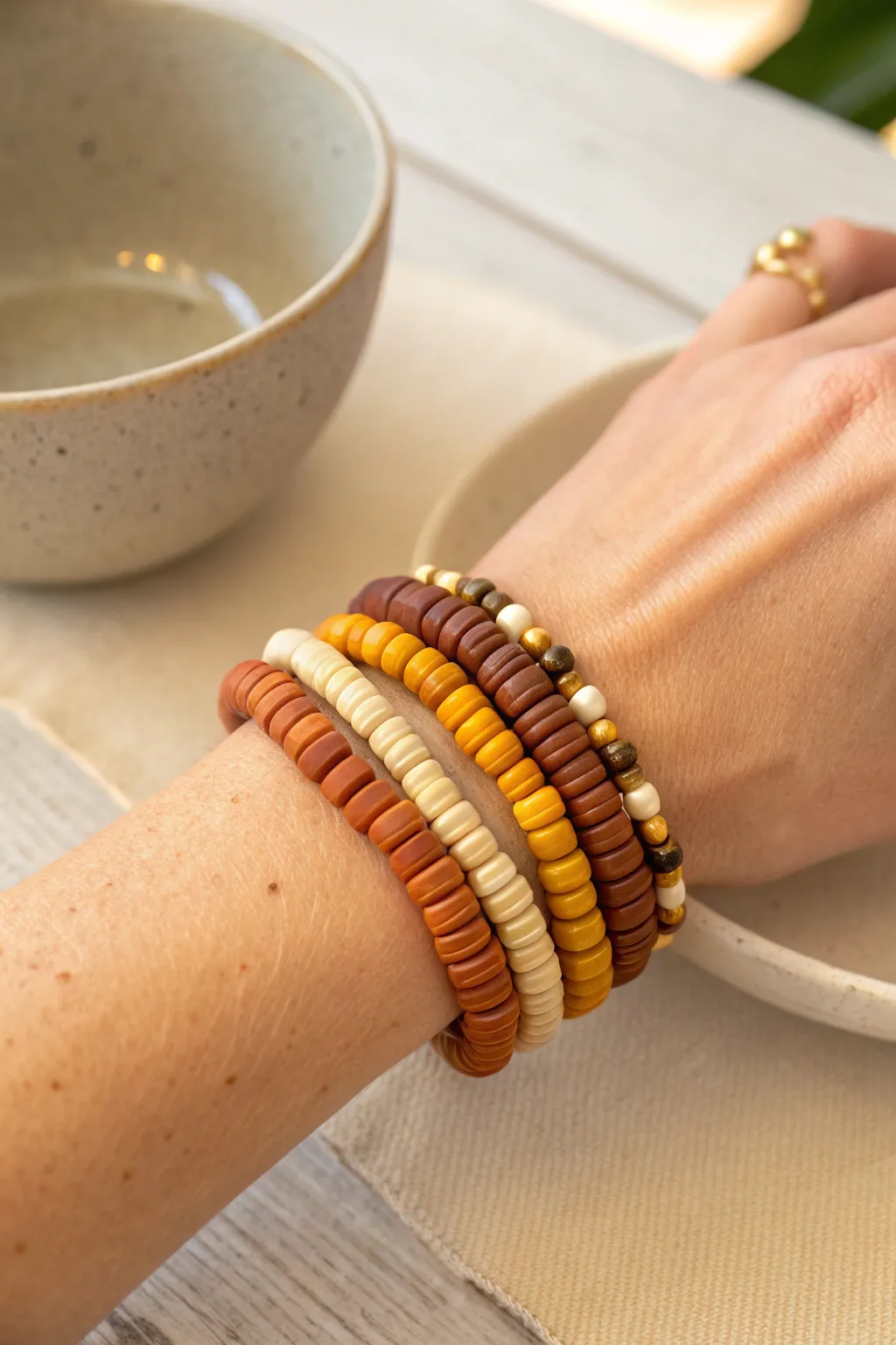 Classic harvest heishi stack in warm autumn tones, finished with subtle gold spacers