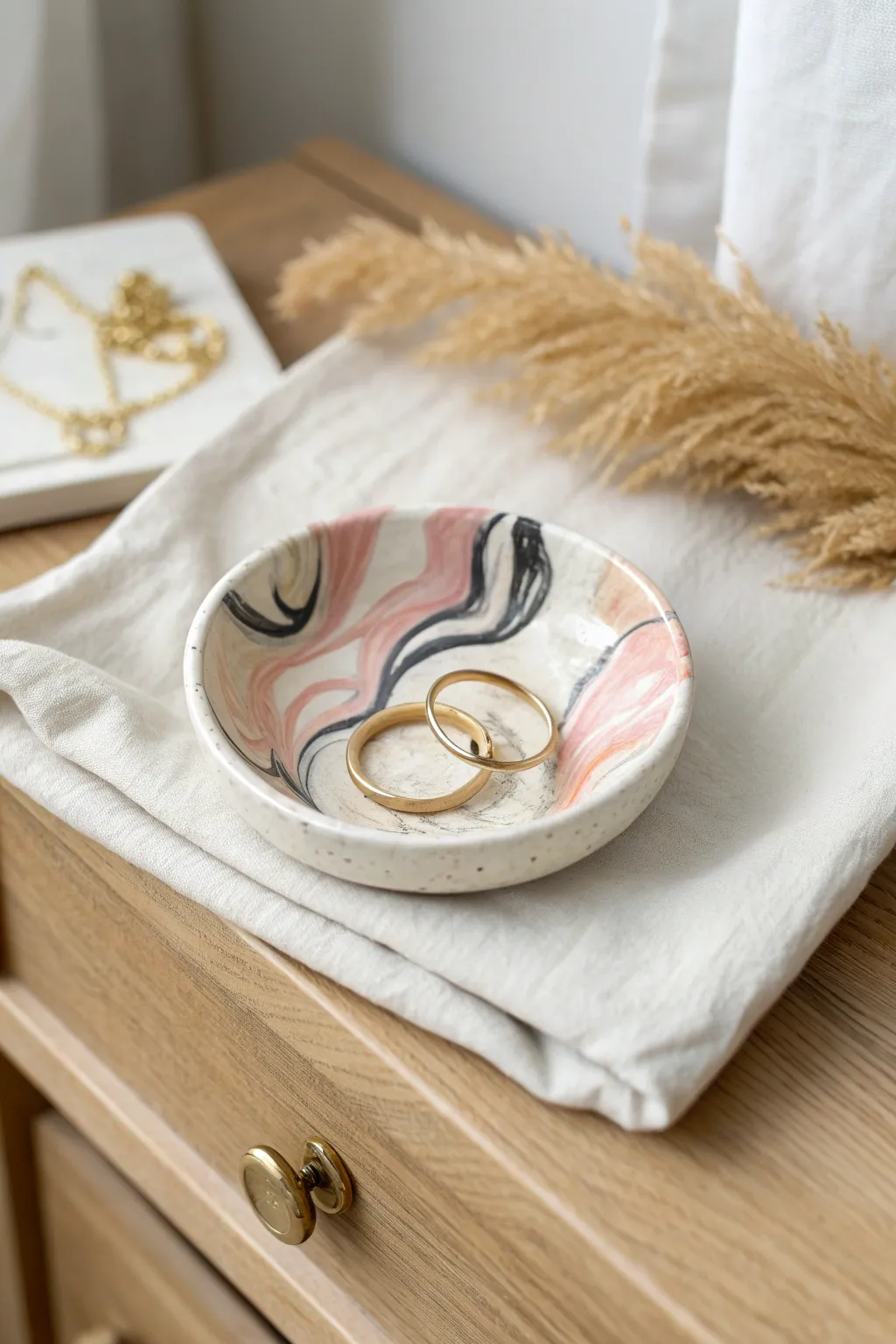 Soft marbled polymer clay ring dish in blush and cream, a simple pretty catchall for jewelry.