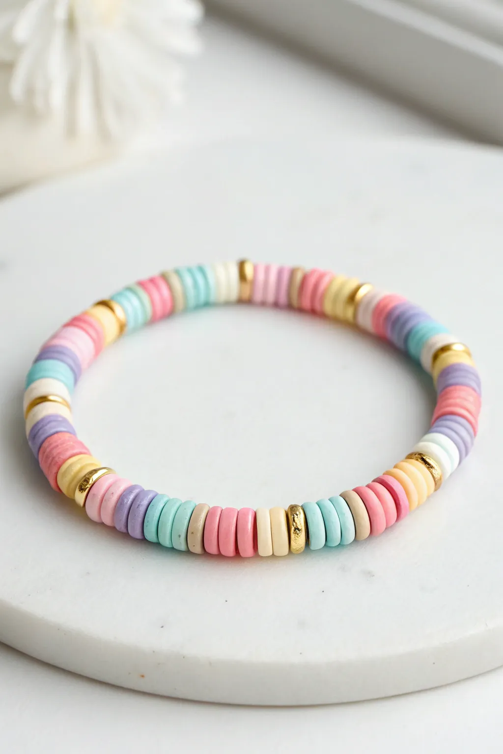 Random confetti heishi clay bead bracelet flat lay for bright, easy DIY summer stacking vibes.