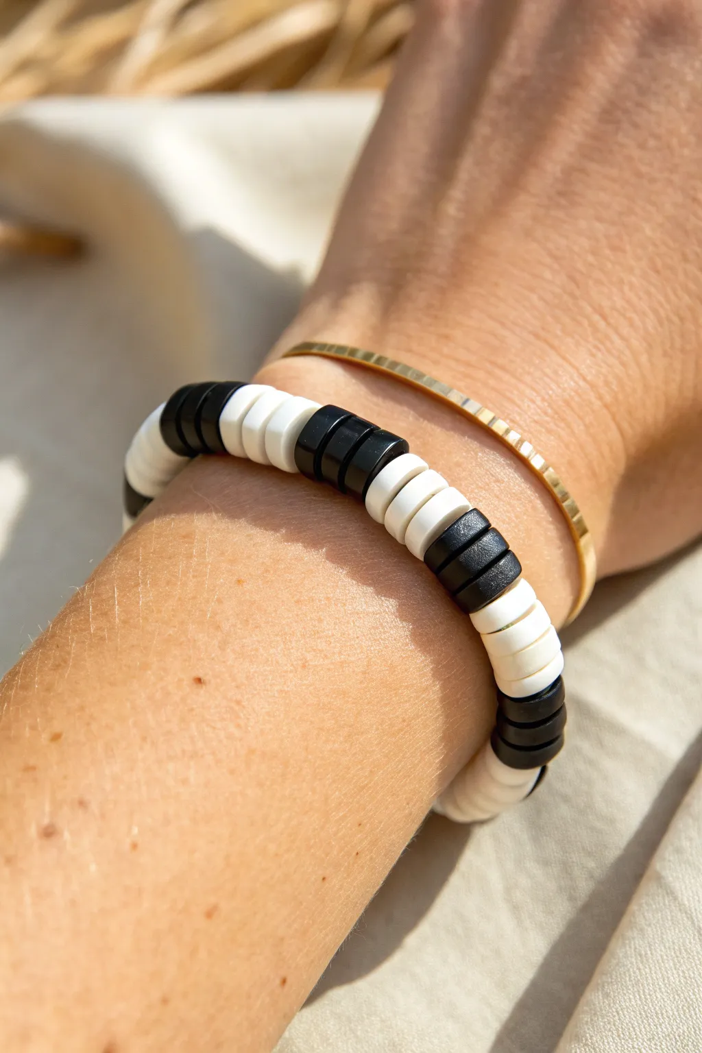 Bold black and white heishi bracelet with classic color block segments, clean and modern on wrist