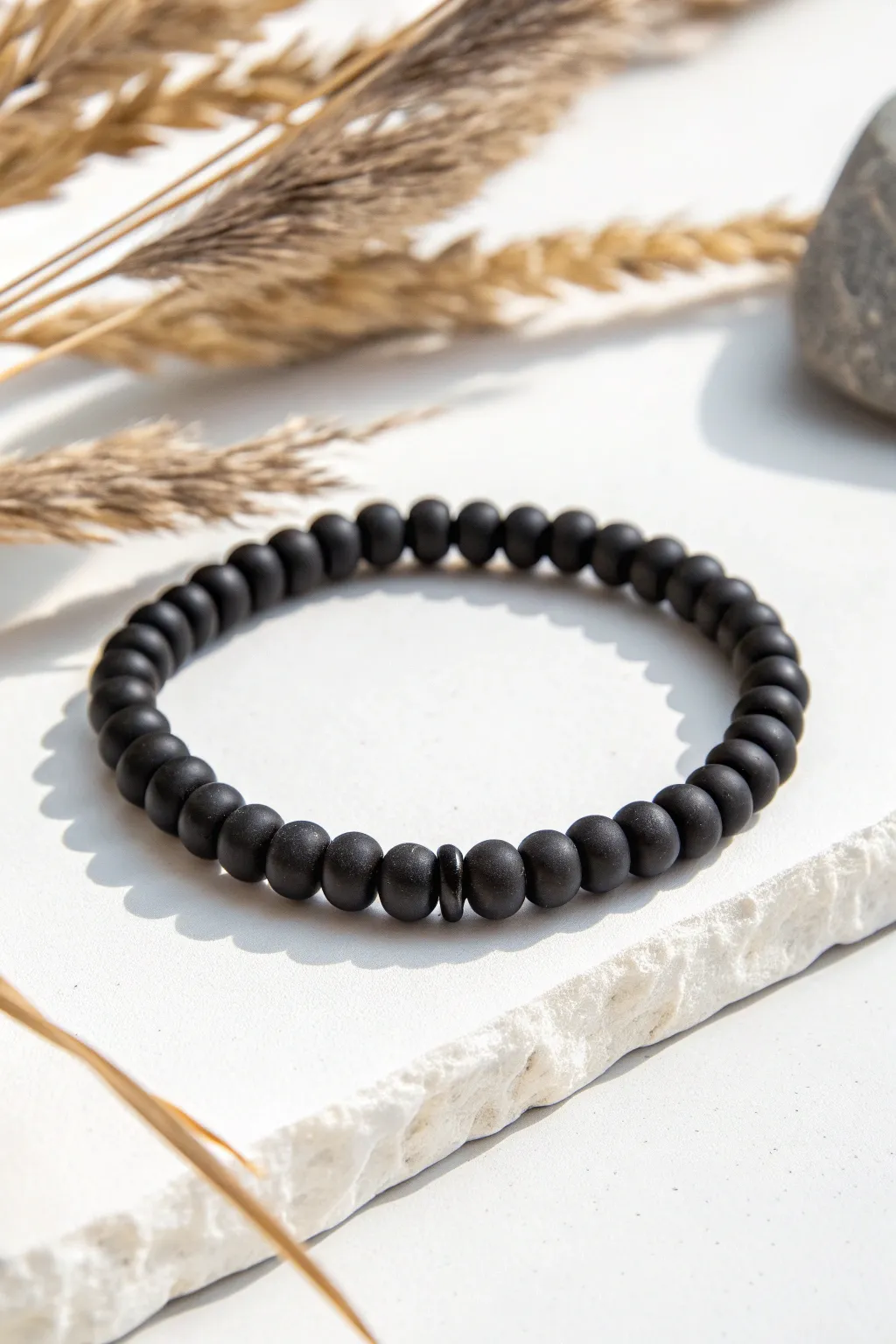Classic all-black heishi bead stretch bracelet with a clean matte finish and modern contrast.