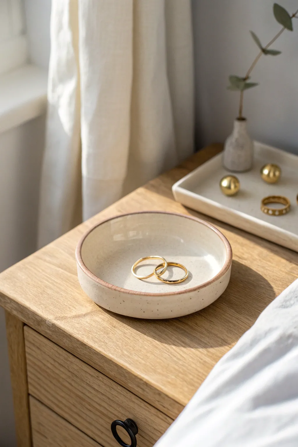 Classic round ring dish tray in soft neutral glaze, styled with simple rings and tiny studs.