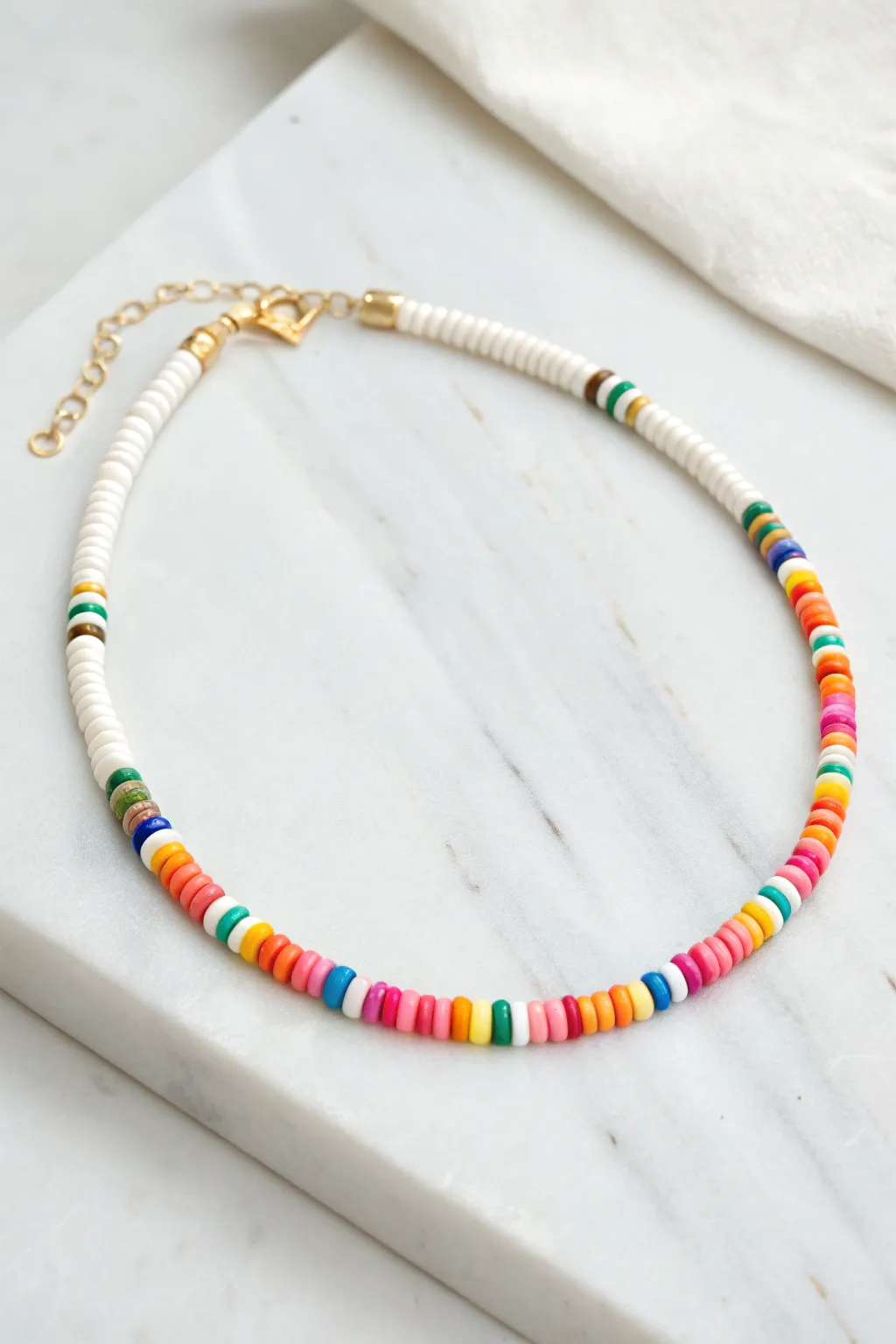 Classic rainbow heishi choker in a clean circle, minimalist styling with a simple clasp and extender