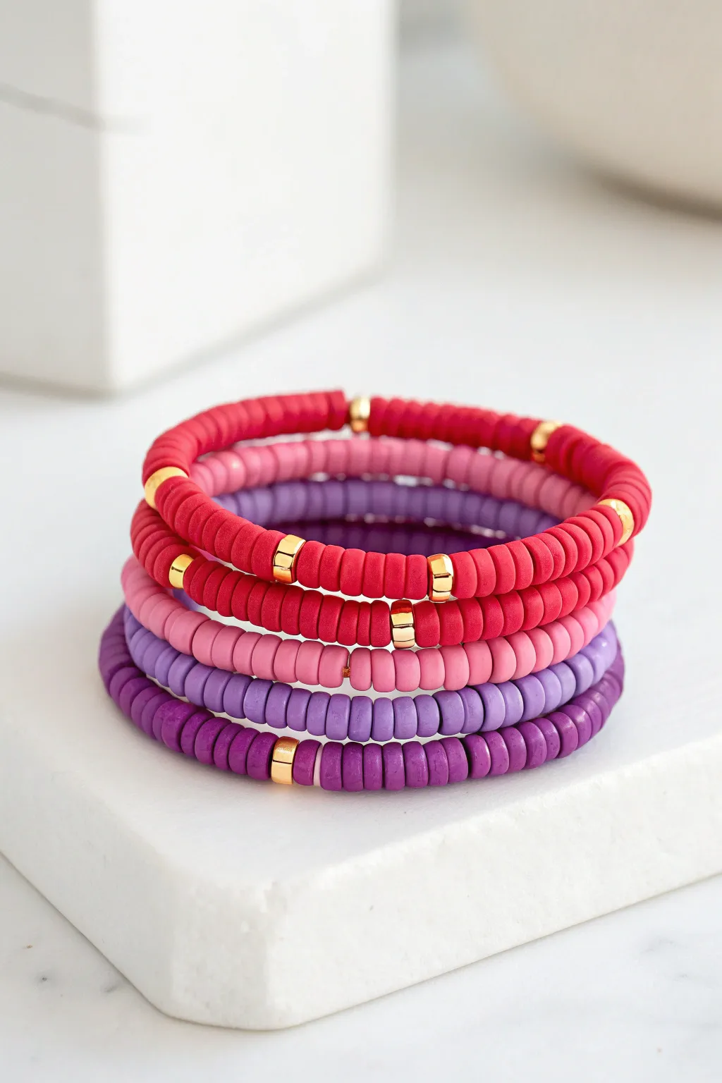 Classic rainbow heishi stack: five bright bracelets, minimalist boutique styling, ready to sell.