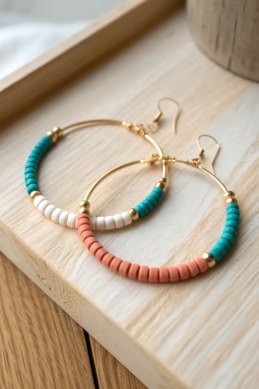 Classic color-block heishi bead hoops in teal, white, and coral for an easy handmade statement.