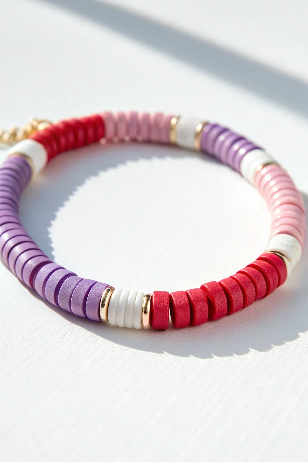 Classic rainbow-order Heishi bead bracelet on bright white, minimal, cheerful, and handmade