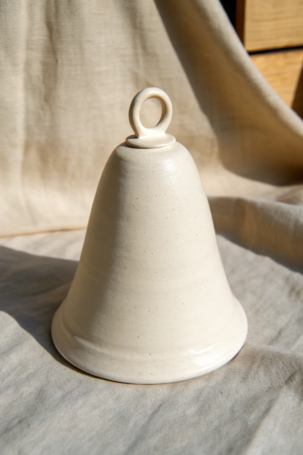 Glossy handbuilt bell cone with a simple loop, clean lines, and calm Scandinavian warmth