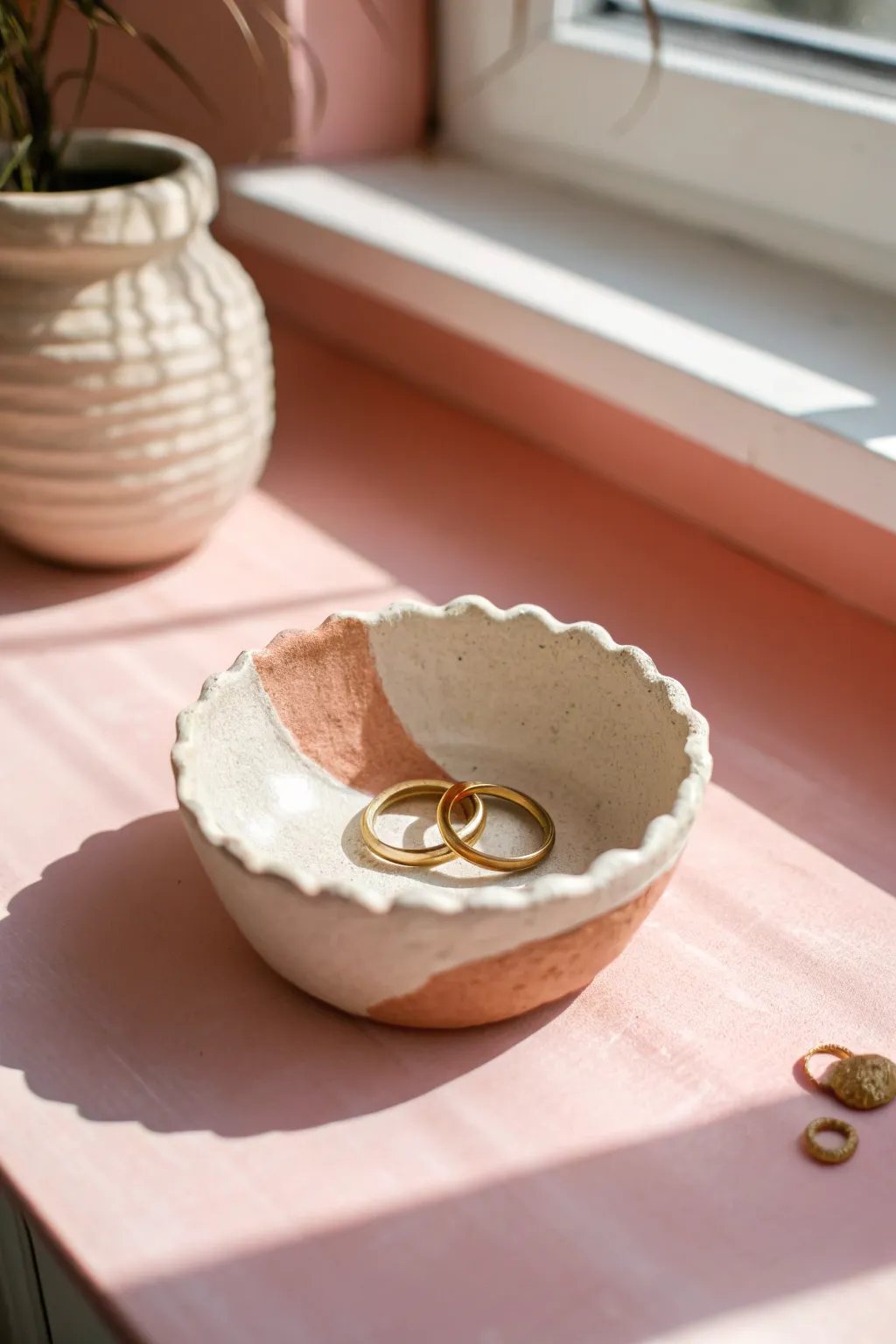 Simple two-tone pinch pot trinket dish with a scalloped rim, styled with rings for easy DIY inspo