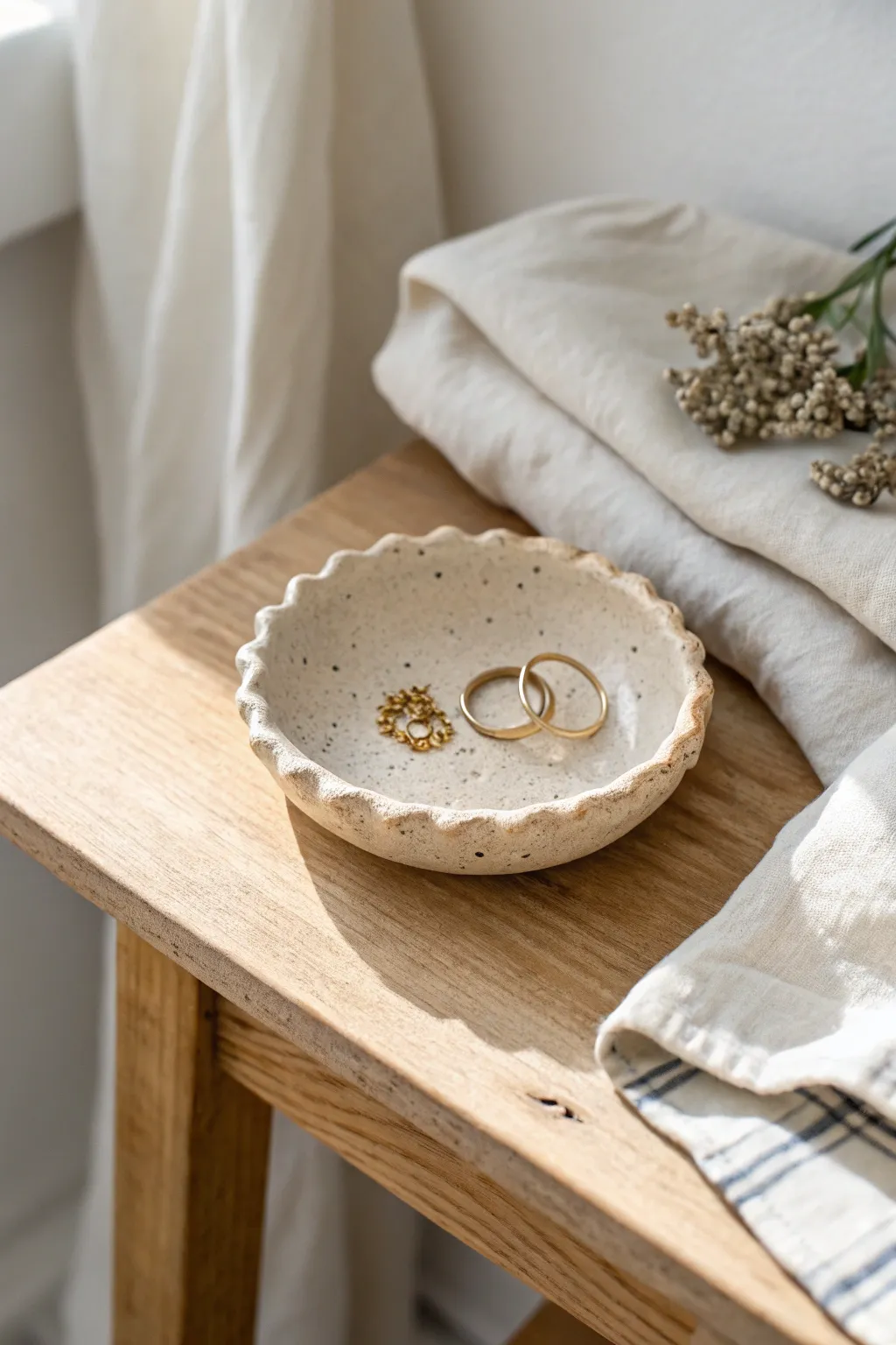 Classic pinch-pot ring dish with soft edges, warm neutrals, and a cozy minimalist bedside feel.