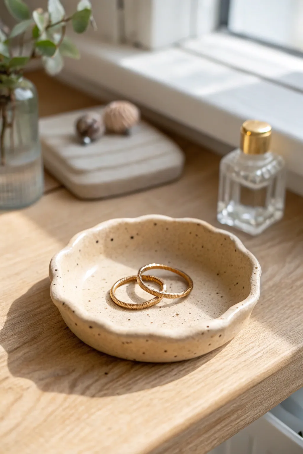 Minimalist wavy-rim ring dish in warm clay tones, styled simply for a calm vanity moment.