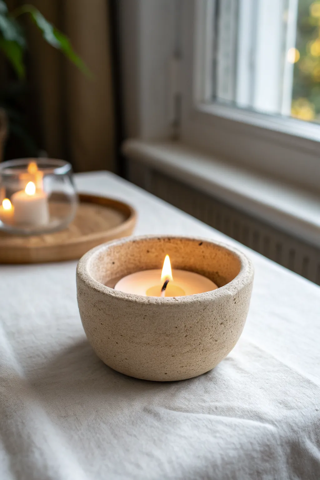 Classic pinch-pot tea light cup with warm glow, minimalist clay charm for cozy evenings.