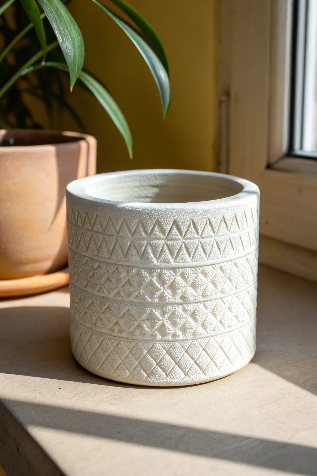 Minimal stamped clay planter with a repeating pattern, simple glaze, and cozy Nordic calm.