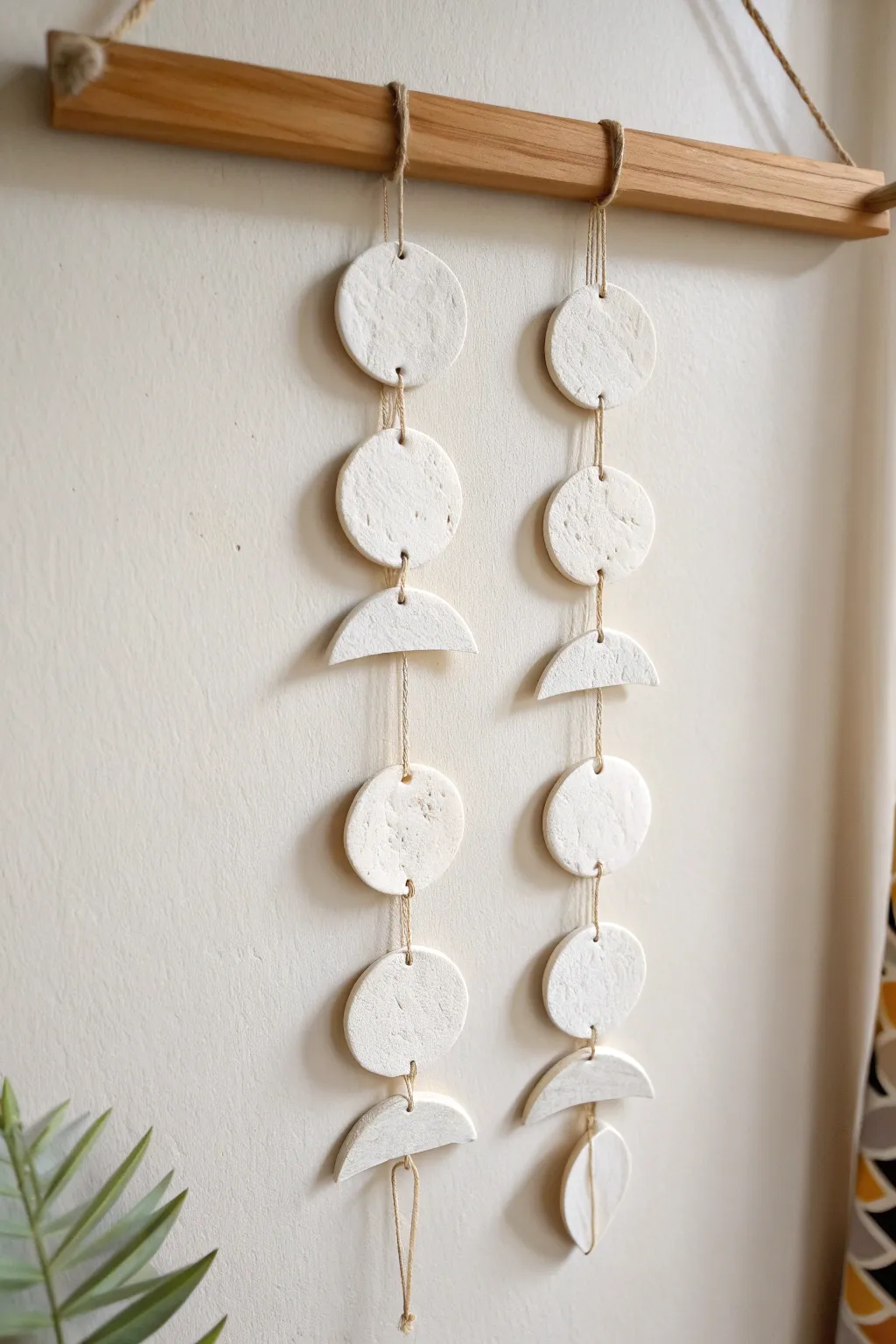 Minimal clay moon phase wall hanging in soft matte white for a calm Scandinavian boho vibe
