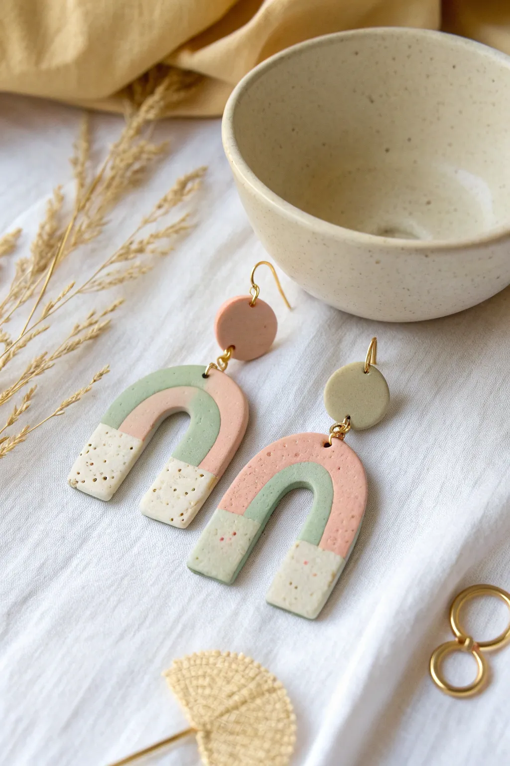 Pastel polymer clay arch dangle with playful dot accents, minimalist and sweet for everyday wear