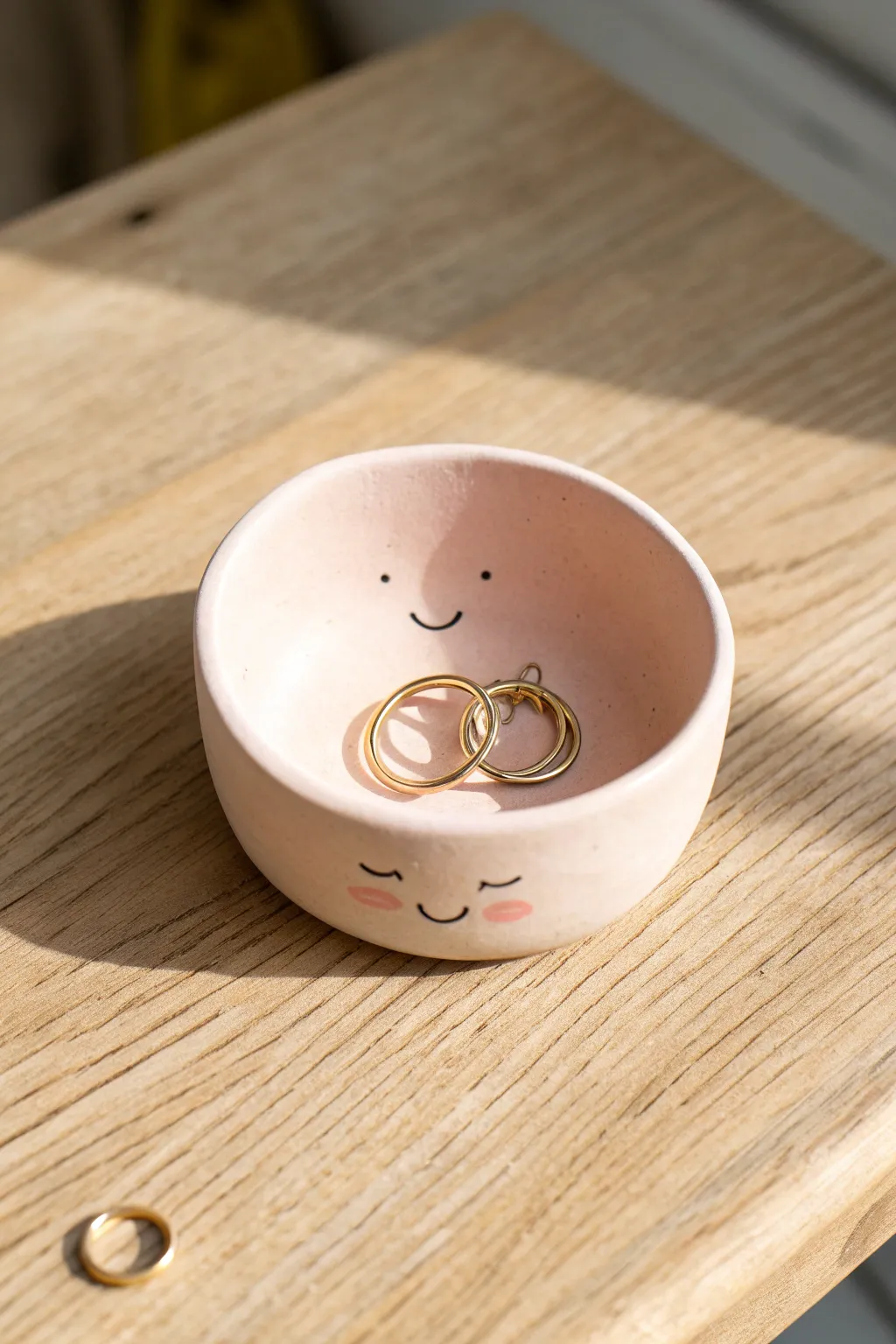 Smiley pinch-pot trinket dish in soft pastel, perfect beginner clay project for tiny treasures.