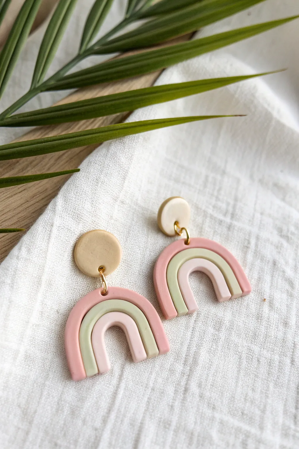 Pastel arch dangles in soft matte clay, clean Scandinavian styling and airy contrast
