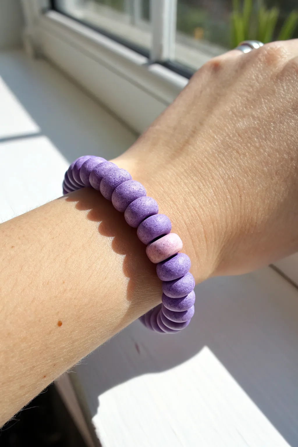 Lavender-to-violet ombre clay disc beads for a dreamy stack that pops on a clean backdrop.