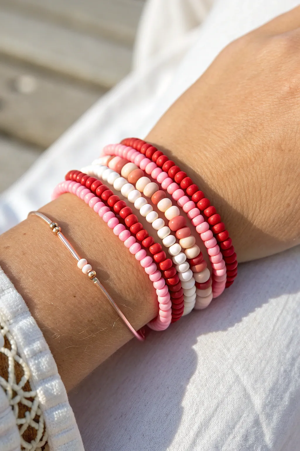 Pink-to-red ombre heishi stack with crisp white breaks, perfect cute Valentines bracelet inspo.