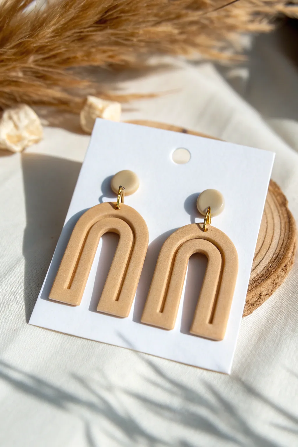 Minimal arch dangle clay earrings in warm neutral matte, simple and modern DIY inspiration
