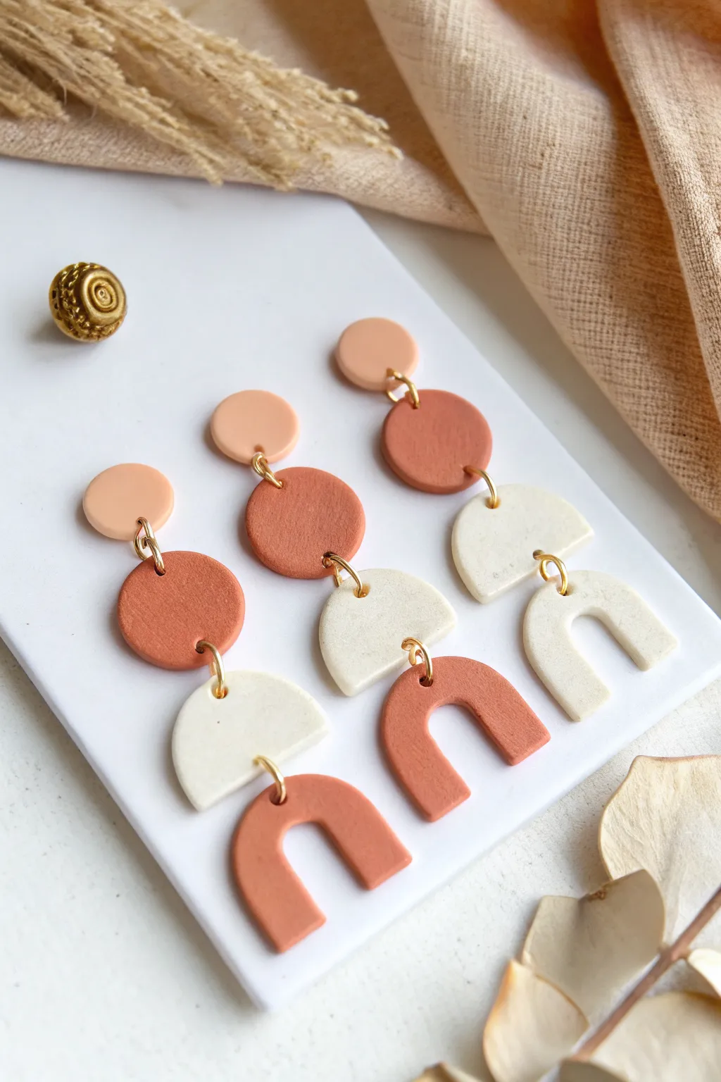 Easy geometric polymer clay earrings in soft neutral tones, clean minimalist layout with boho warmth.