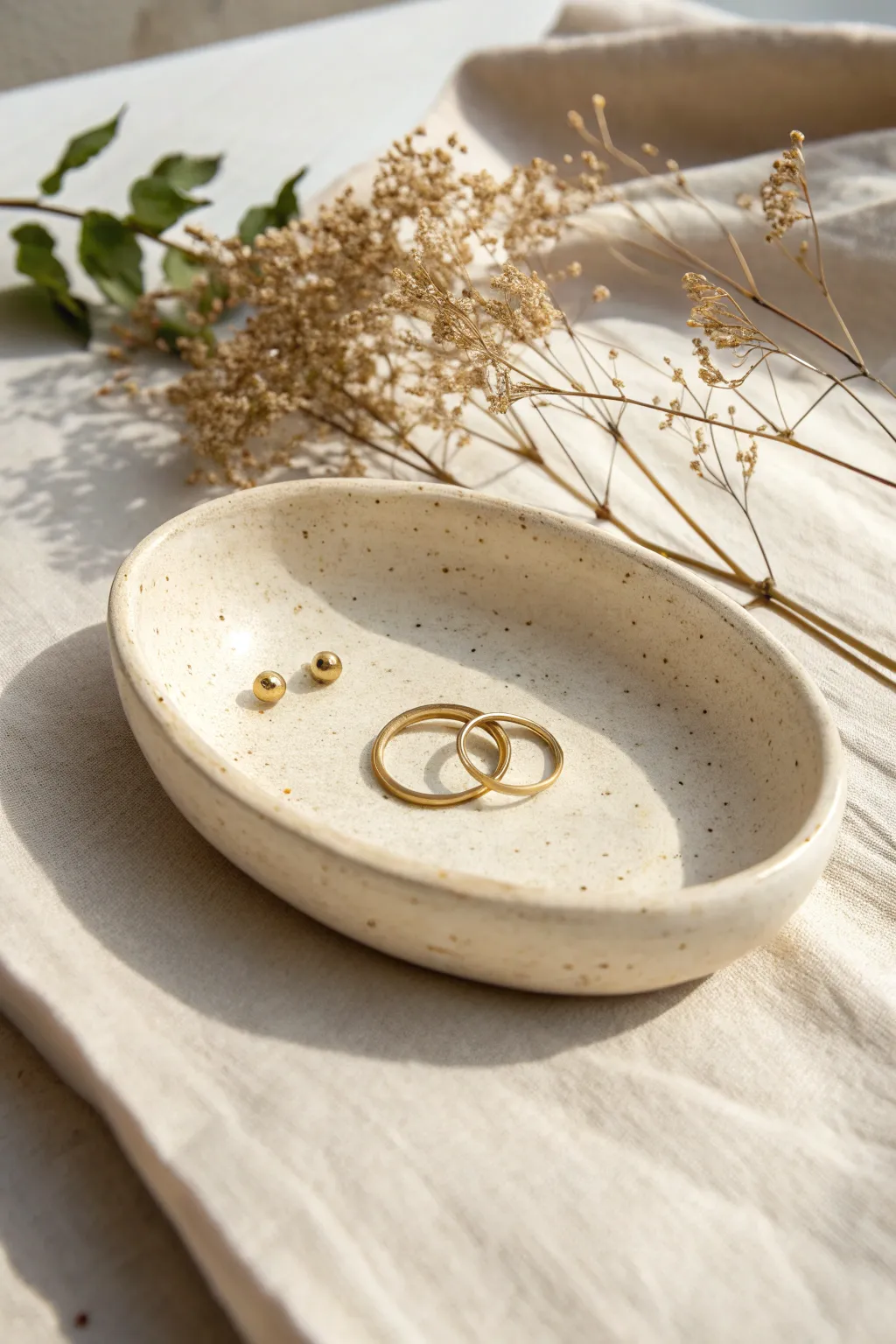 Minimal speckled clay trinket dish with rings and a key, modern and calming for any space