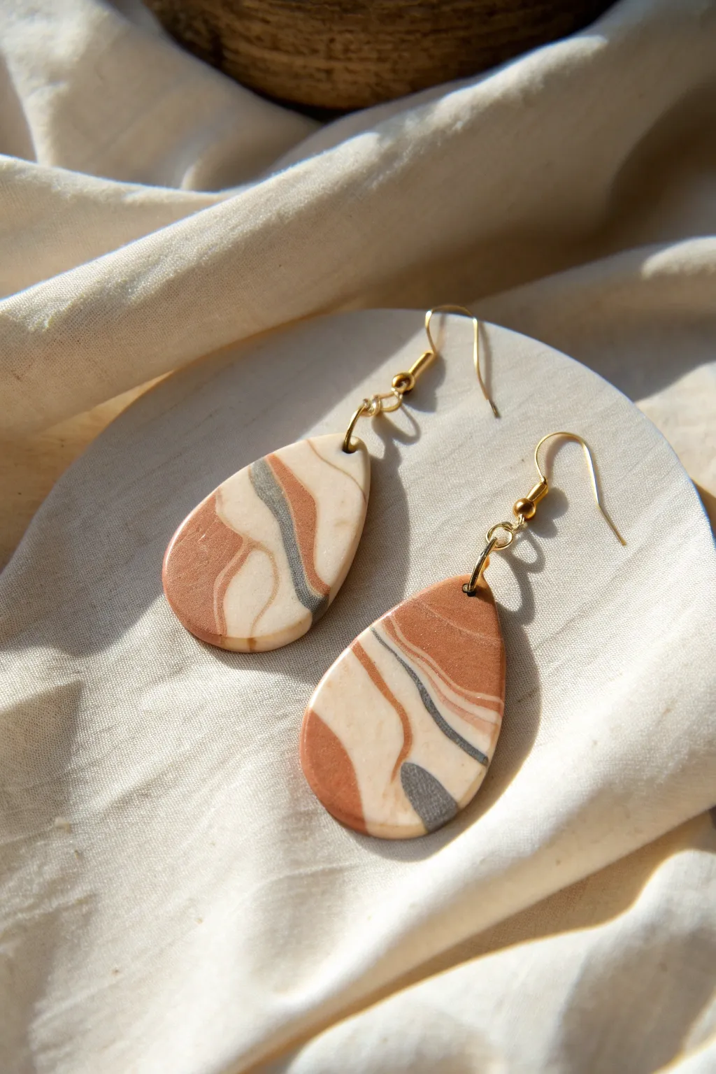 Marbled polymer clay statement earrings on linen, minimalist Scandinavian boho charm.
