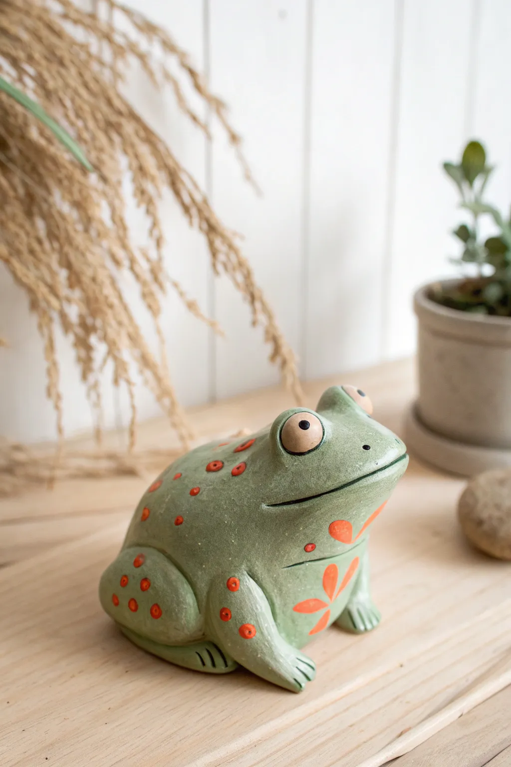 Sweet pinch pot frog with dot eyes and bright details, a simple kid-friendly clay critter idea