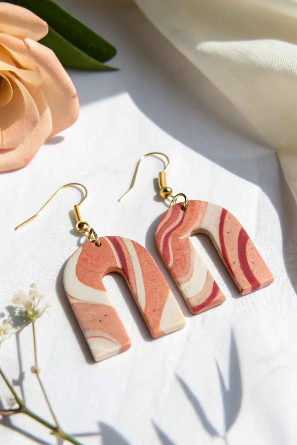 Bold marbled polymer clay arch earrings in warm neutrals, minimal style with a soft boho touch