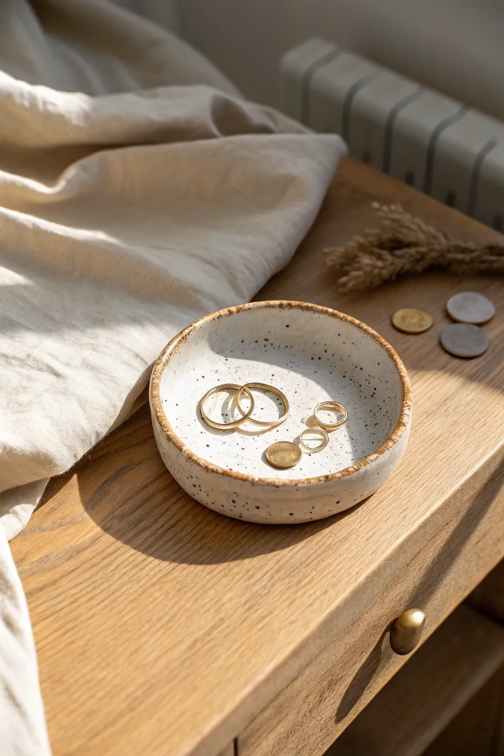 Minimalist clay trinket dish keeps your daily essentials tidy with warm, cozy bedside style.
