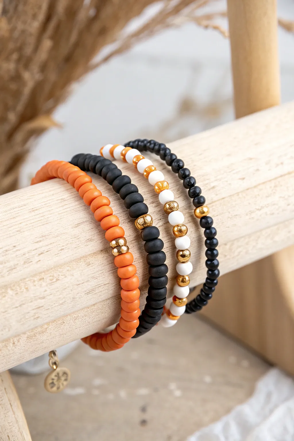 Classic Halloween heishi stack in orange, black, and white with subtle metallic accents