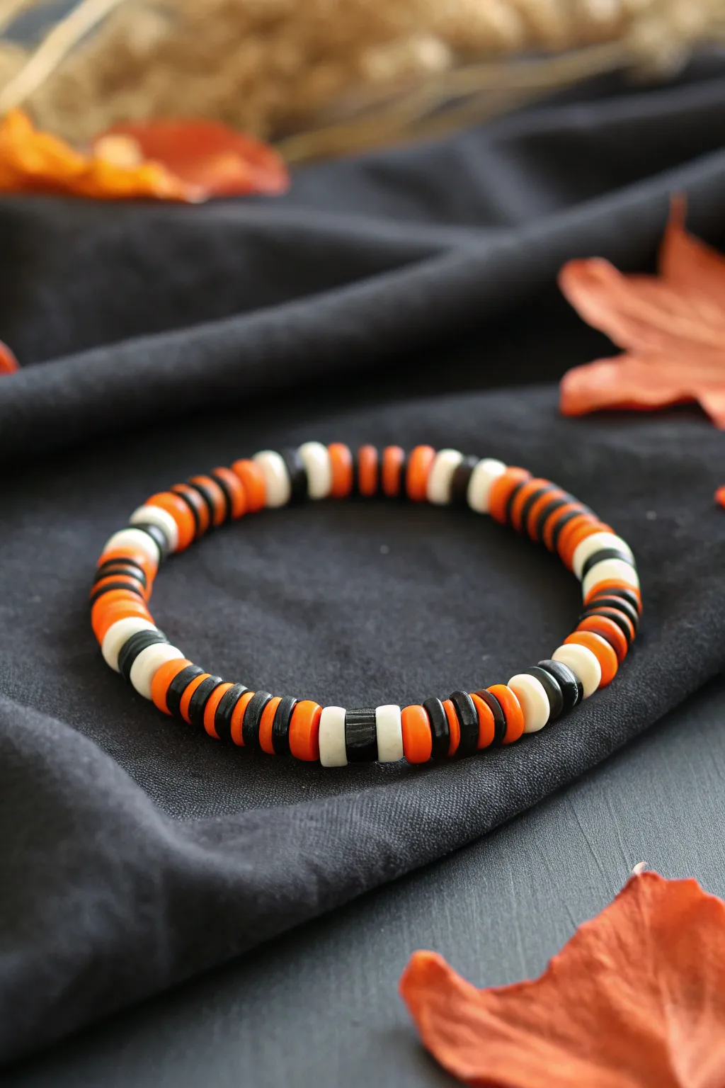 Classic orange, black, and white striped clay heishi bracelet for a cozy Halloween look