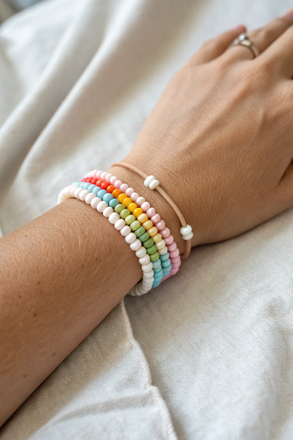 Classic rainbow heishi stack in bright, pastel, and white-spaced patterns for an effortless pop