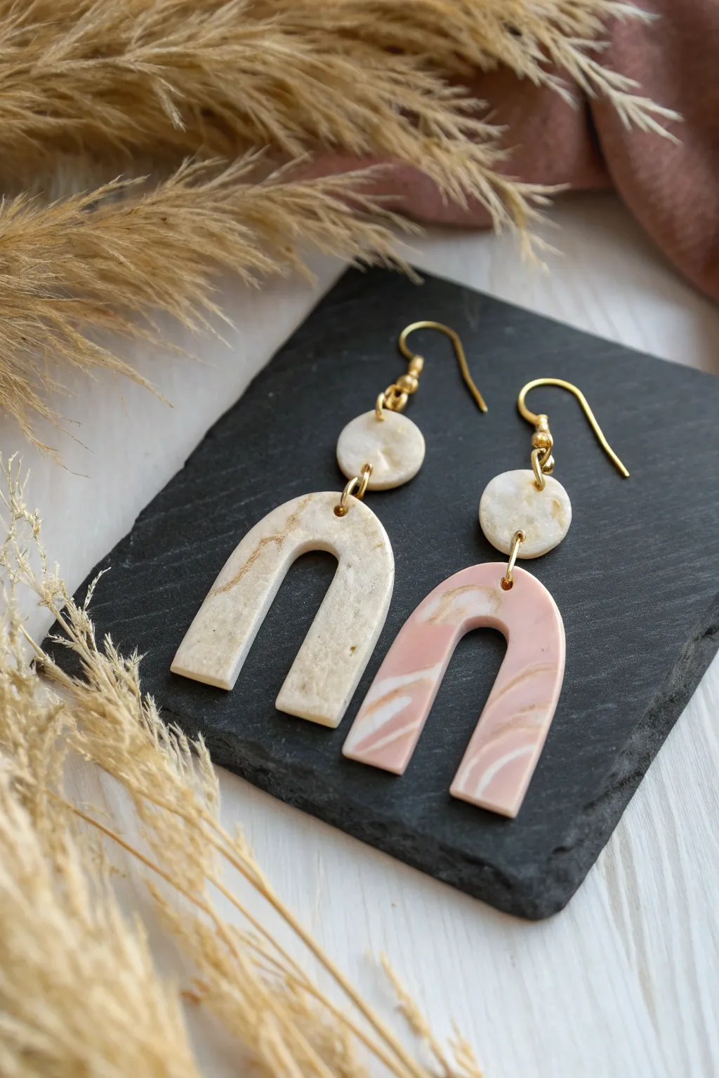 Glossy mold-poured liquid clay arches with minimal gold hardware, modern and handmade.