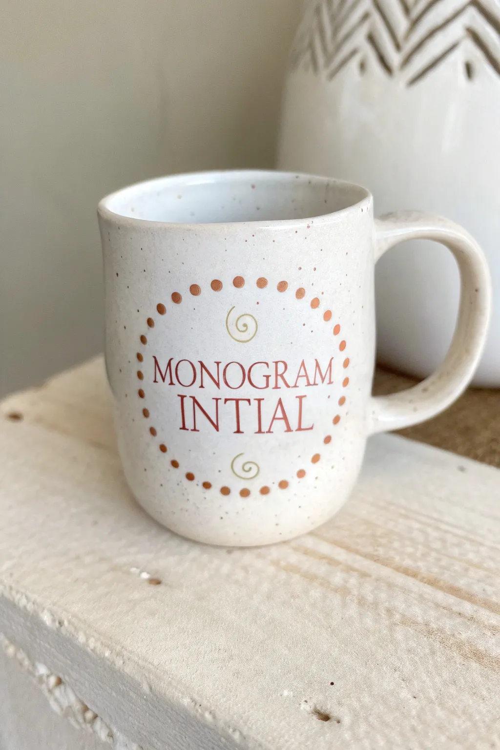 Simple monogram mug with a dotted halo in blush and sage for a clean, cozy Scandinavian look.