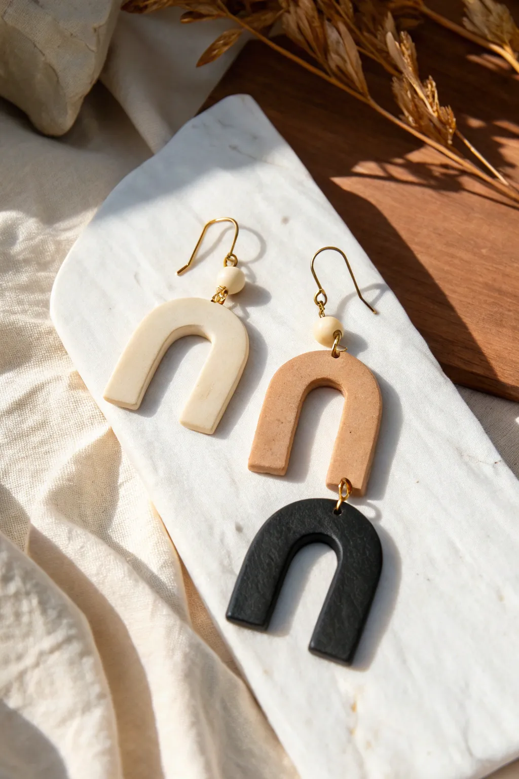 Classic arch dangle earrings in oven-bake clay, simple neutrals for timeless DIY jewelry.