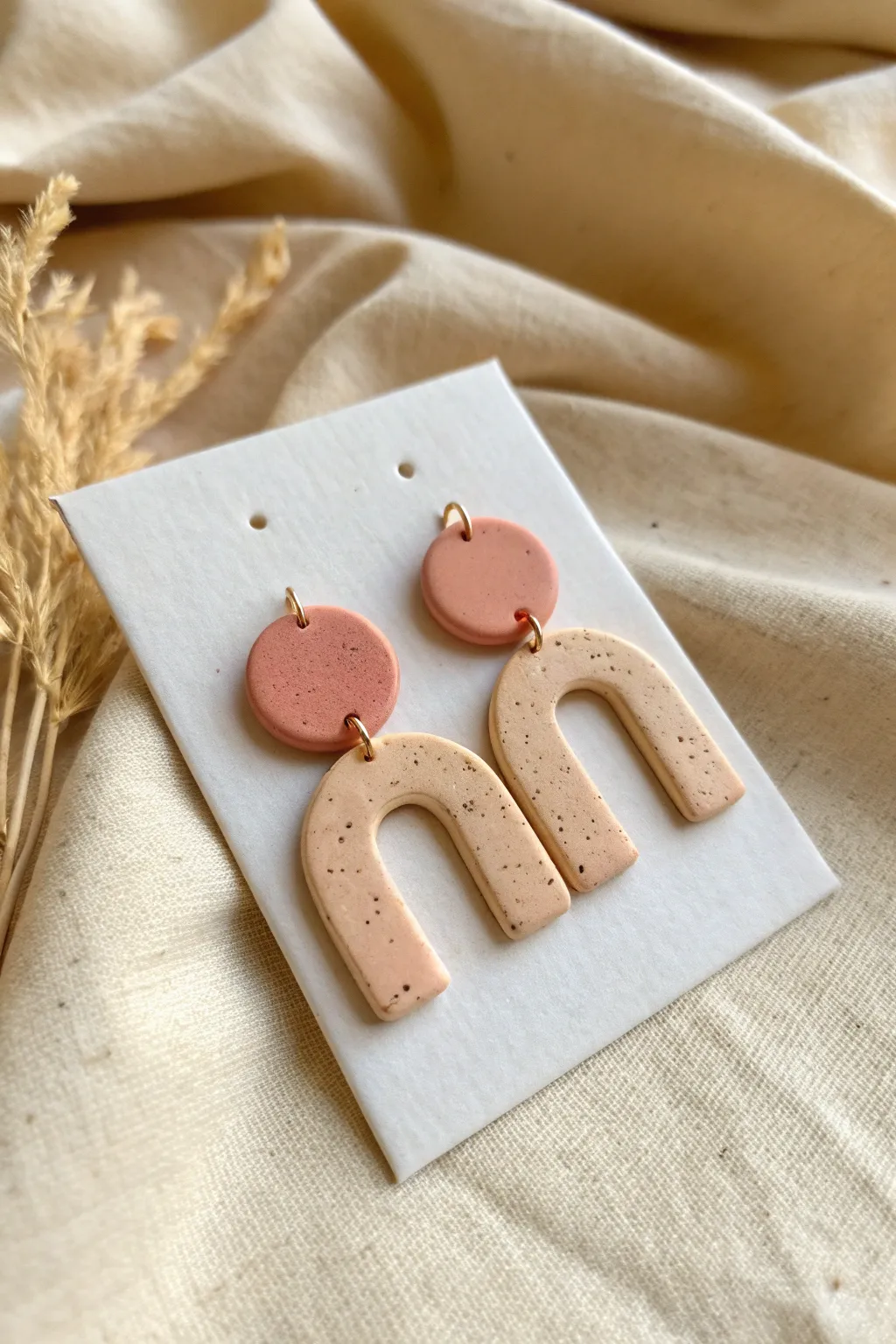 Easy bold polymer clay earrings in soft pastels with speckles, styled minimal on linen