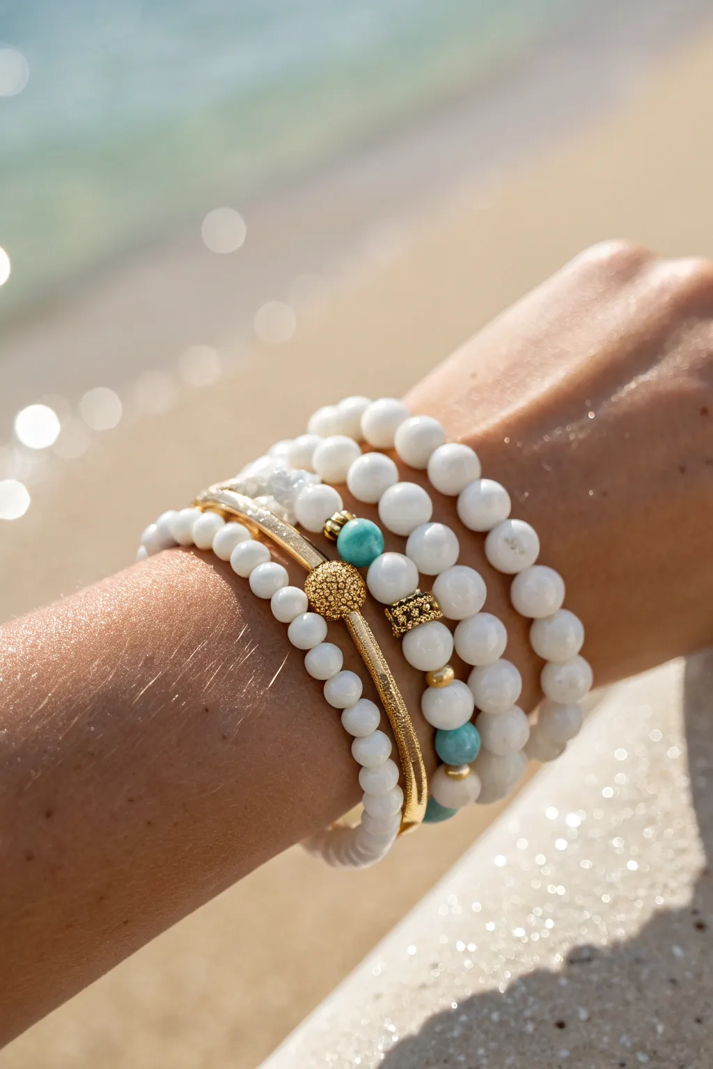Classic white, gold, and aqua clay bead bracelet stack for a preppy beach look, clean and effortless