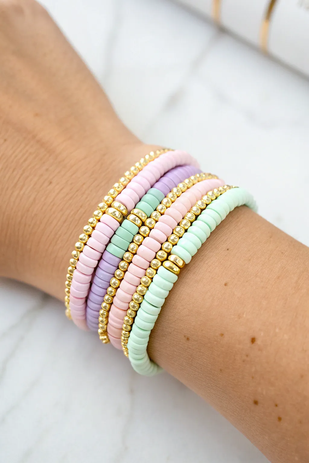 Classic pastel heishi stack with tiny gold spacers for an easy preppy clay bead look
