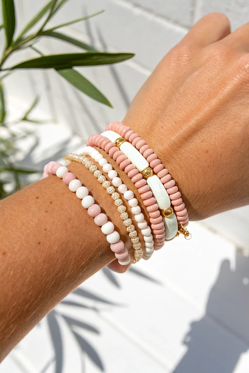 Classic preppy stack: blush pink, crisp white, and gold accents for a clean summer look