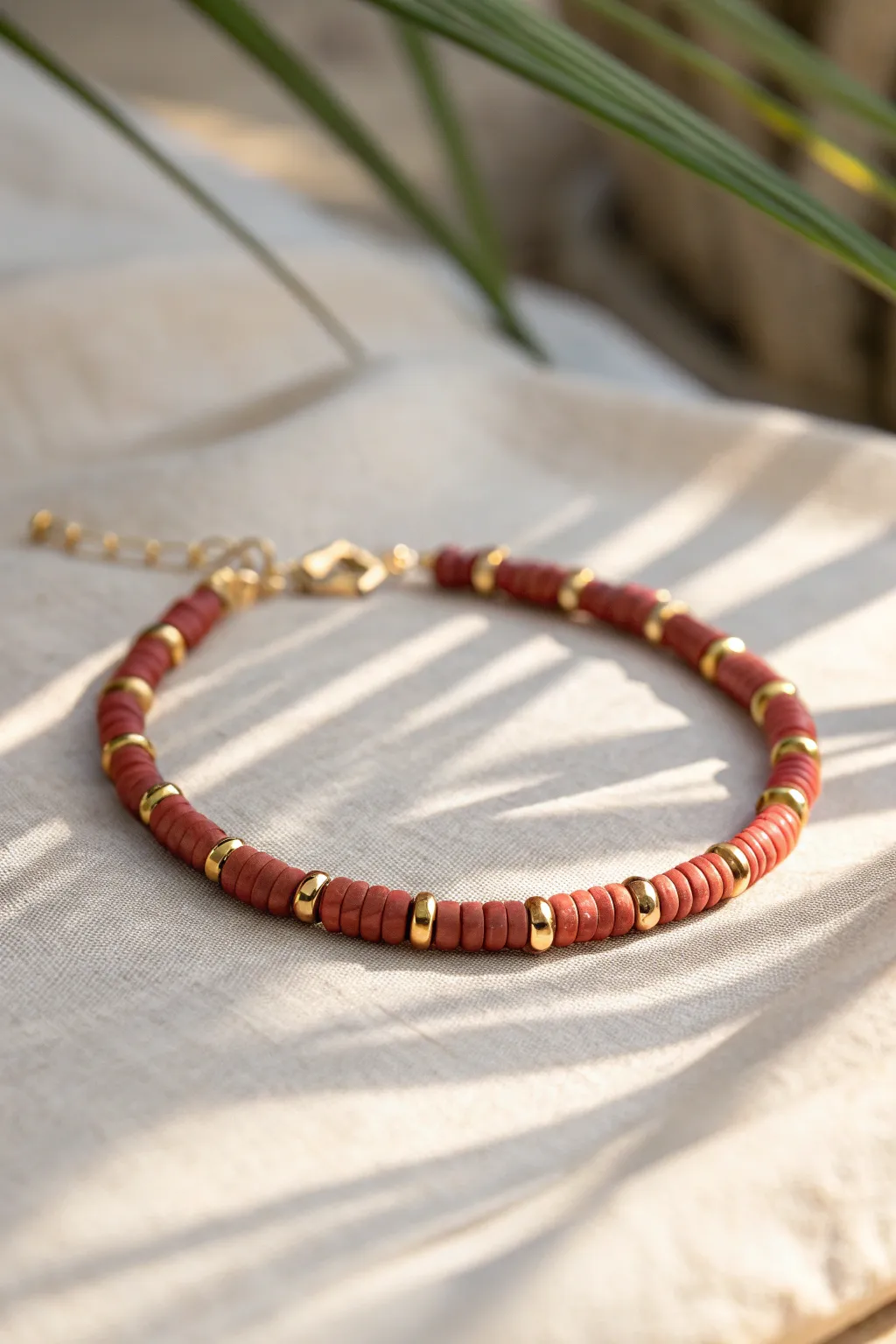Classic red heishi bracelet accented with tiny gold spacers for a clean, timeless look