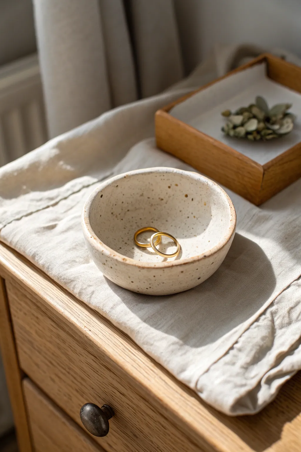 Classic pinch pot bowl: a simple handmade trinket dish for rings on a calm nightstand.