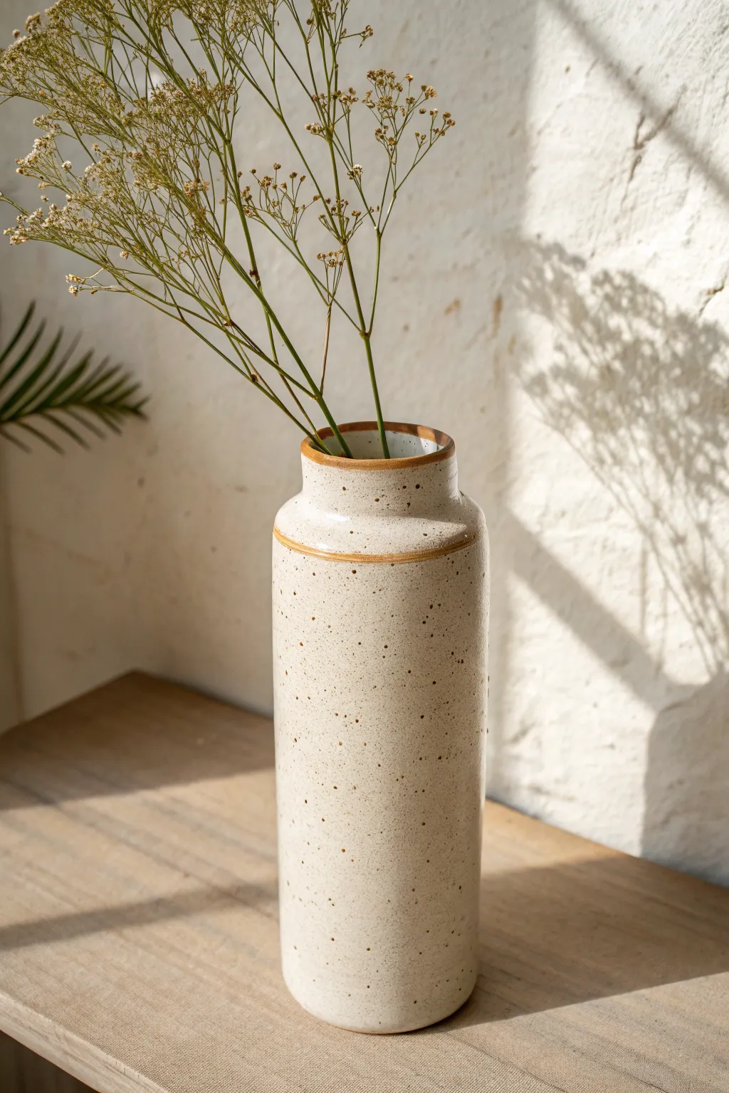 Classic slab cylinder vase with a clean seam detail, styled in soft light and warm neutrals