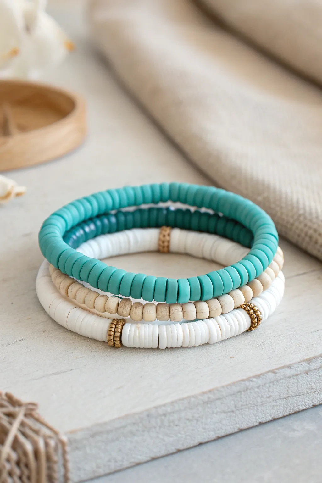 Classic teal and white heishi bracelet stack with clean color-blocking and calm Scandinavian style.