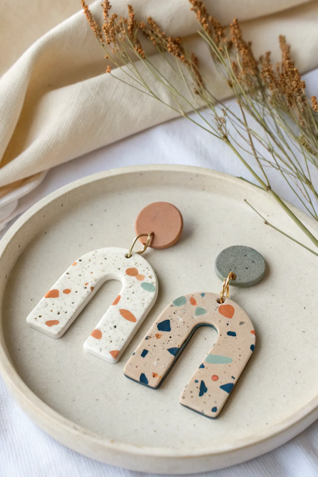 Bold terrazzo arch earrings in two soft palettes, styled minimal on linen for modern boho vibes