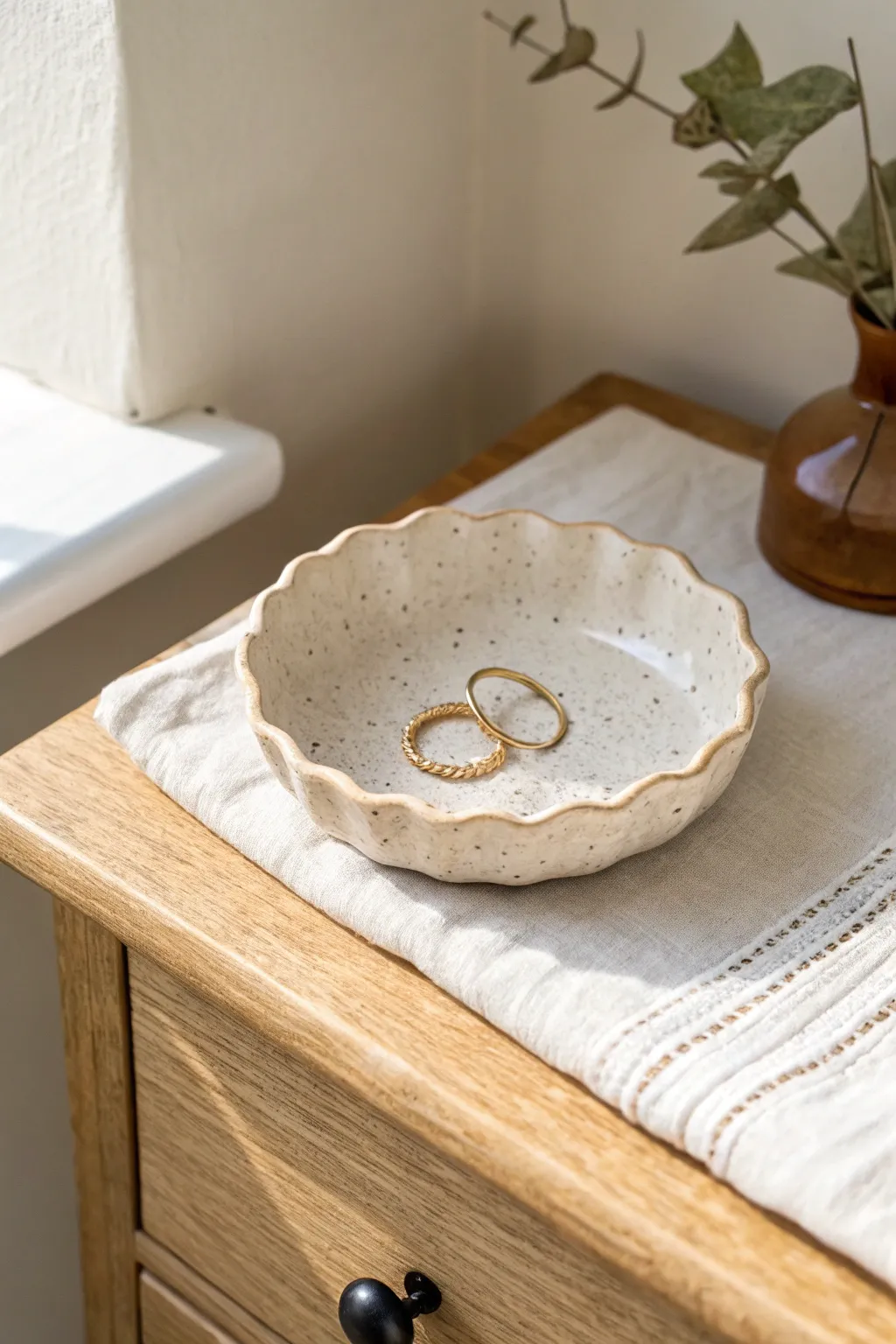 Minimal wavy clay ring dish in warm ivory, perfect for rings and hair pins on your nightstand